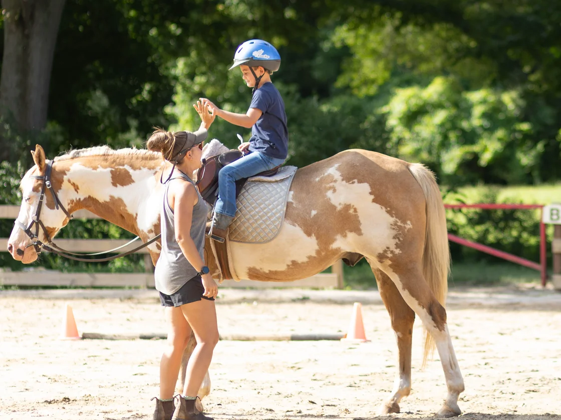 Trainer working with a young rider at Horses and Hope barn in Talmo, Georgia